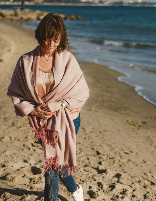 Natalie Hall, hypnotherapist, walking on a Dorset beach.